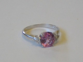 A lady's 18ct gold dress ring set a pink sapphire supported by 6 diamonds to the shoulders