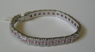 A lady's handsome 18ct white gold bracelet set 34 pink square cut sapphires surrounded by diamonds