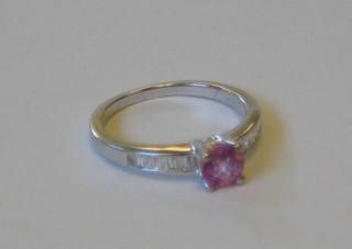 A lady's 18ct gold dress ring set a circular pink sapphire and baguette cut diamonds