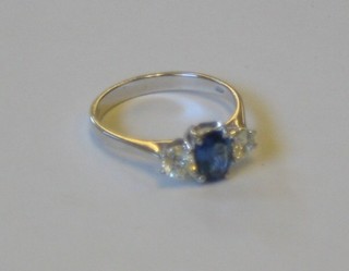 A lady's 18ct white gold dress ring set an oval sapphire and 2 diamonds