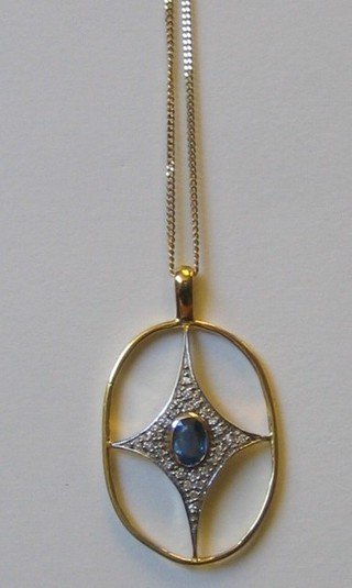 A stylised 18ct yellow gold cross pendant, set a sapphire to the centre surrounded by numerous diamonds, hung on a gold chain