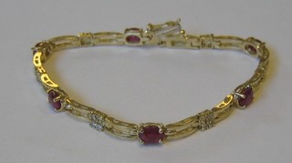 An lady's attractive 14ct  yellow gold bracelet interspaced oval cut rubies and 4 diamonds