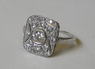 A lady's 18ct white gold dress ring set a large diamond supported by numerous diamonds (in all 0.65ct)