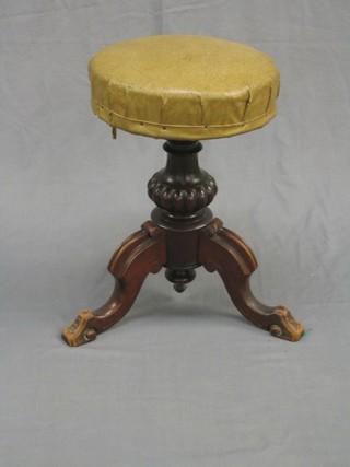 A Victorian carved mahogany adjustable piano stool raised on bulbous turned and tripod supports (with old repair to the leg)