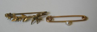 A gold bar brooch set a seed pearl together with a gilt metal bar brooch
