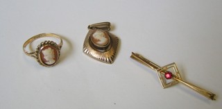 A 9ct gold bar brooch set a red stone, a gold cameo dress ring and a ditto pendant