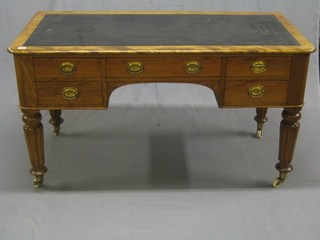 A Victorian bleached mahogany pedestal writing table with inset tooled black leather writing surface, above 1 long and 4 short drawers, raised on turned and reeded supports