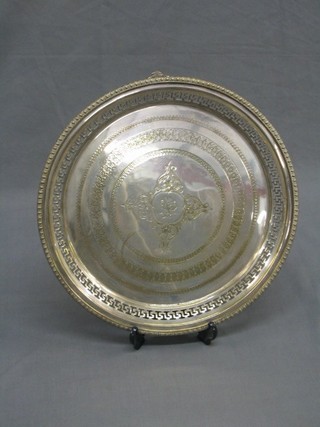A circular pierced and engraved silver plated salver raised on pierced bracketed feet 13 1/2"