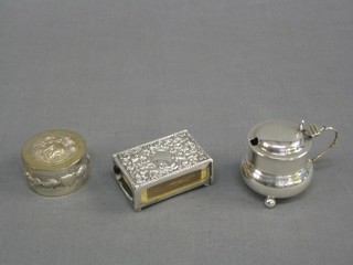 An Edwardian embossed silver match slip Birmingham 1904, a Victorian silver mustard pot and a Ceylonese embossed silver trinket box of circular form