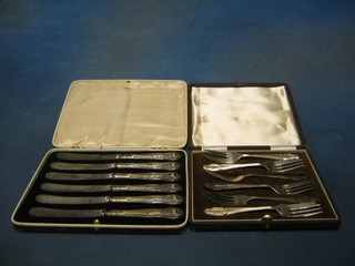 A set of 6 silver plated pastry forks, cased and a set of 6 silver plated tea knives cased
