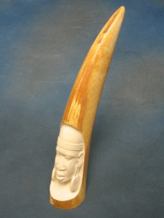 A carved ivory tusk decorated a portrait of a head 13"