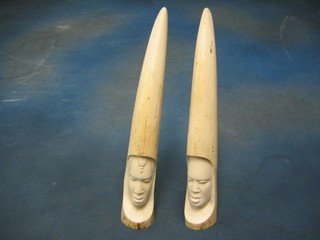 2 carved ivory tusks decorated heads 12"