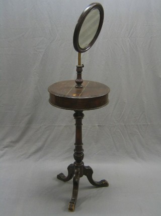 A Victorian oak shaving stand, the base with circular double compartment with hinged lid and raised on pillar and tripod supports