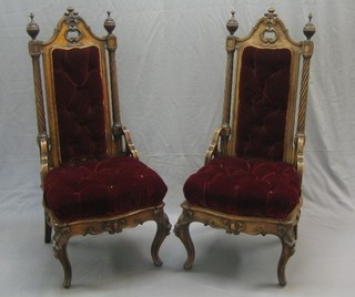 A pair of 19th Century Continental carved mahogany high back chairs with spiral turned columns and pierced Gothic brackets to the sides, upholstered in red button back material, raised on cabriole supports
