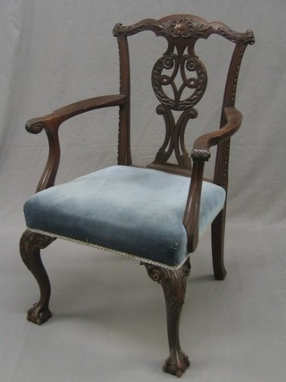 A handsome Victorian carved mahogany Chippendale style carver chair with pierced with shaped splat back, the seat upholstered in blue Dralon and raised on carved cabriole supports by Edwards & Roberts