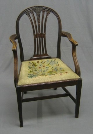 A 19th Century Hepplewhite style carver chair with upholstered drop in seat raised on square tapering supports