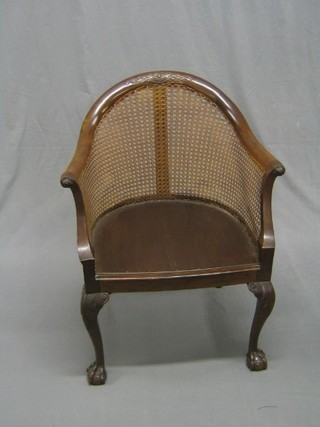 An Edwardian Georgian style tub back library chair with cane back, raised on cabriole supports (seat formerly caned)