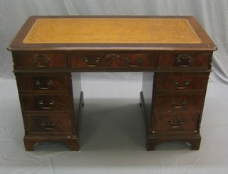A reproduction Georgian style mahogany pedestal desk with inset tooled leather writing surface above 9 drawers, raised on bracket feet 49"