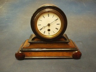 A Victorian French 8 day mantel clock with circular porcelain dial contained in a drum shaped mahogany case