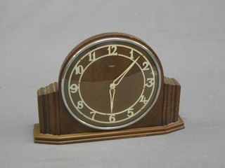 An Art Deco electric clock contained in an oak case with Arabic numerals by Metamec Electric