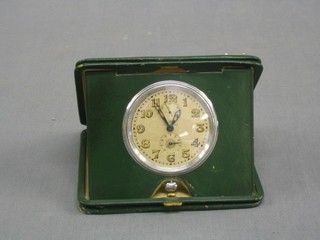 A Longines 8 day travelling clock contained in a leather case
