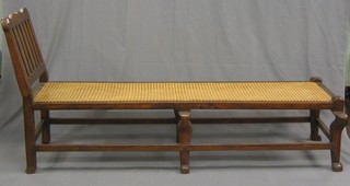 A Victorian 17th Century style oak day bed with woven rush seat, raised on cabriole supports