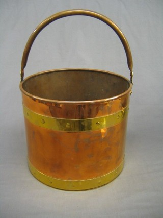 A circular copper and brass log barrel