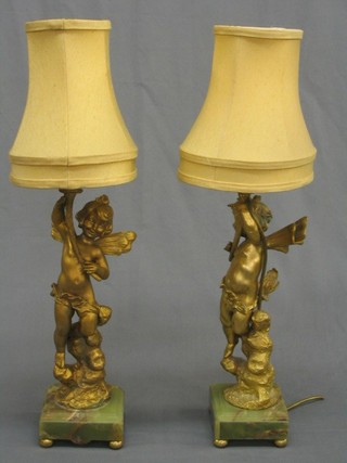 A handsome pair of 19th/20th Century gilt  painted spelter figures of cherubs, converted to electric table lamps, raised on green veined marble bases, complete with shades