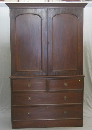 A Victorian mahogany linen press with moulded cornice, the interior with no trays enclosed by panelled doors, the base fitted 2 short and 2 long drawers (missing 1 escutcheon) 48"