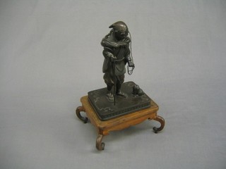 A handsome 19th Century Japanese bronze figure of a standing gentleman with monkey and dog, raised on hardwood stand, 12"