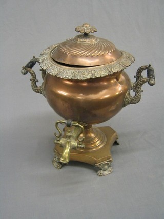 A 19th Century copper twin handled tea urn with ebony handle (slight dent)