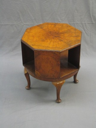 An Art Deco figured walnut octagonal revolving bookcase, raised on cabriole supports 18"