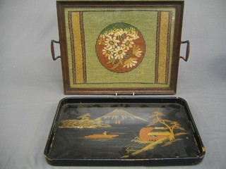 A twin handled Oriental lacquered tray and a tray with embroidered insert