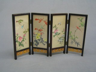 A 20th Century Oriental style 4 fold table screen decorated landscape prints