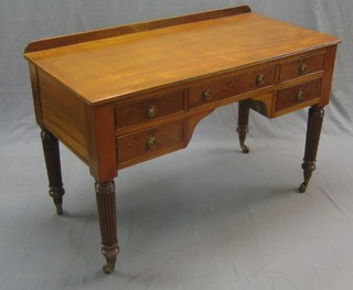 A Victorian mahogany writing table, fitted 1 long drawer flanked by 4 short drawers, raised on turned and reeded supports 48"