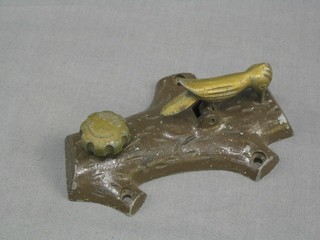 A 1930's alluminium Patented door knocker in the form of a  woodpecker 6"