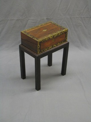A Victorian rosewood and brass inlaid writing slope with hinged lid, raised on a later associated base (some brass rising in places) 14"