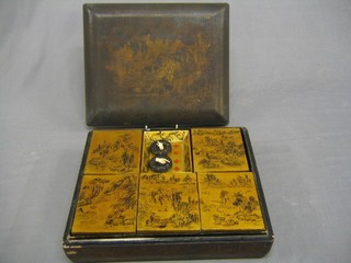 A 19th Century Oriental lacquered game box containing 5 lidded boxes containing 1 rectangular carved mother of pearl panel, various ivory panels, 9 circular white ivory counters, 21 carved red counters in the form of fish (some f) and 20 white carved fish counters, trays depicting King and Queen of diamonds, 1 King of Diamonds etc and 2 ebony and ivory finger indicating dice