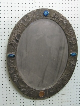 A bevelled plate wall mirror contained in an embossed pewter and hardstone mounted frame 20" (some tears and damage to side)