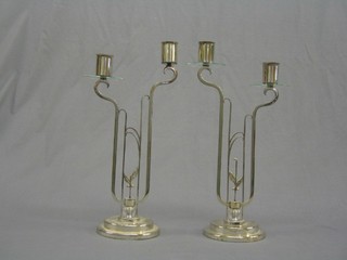 A pair of Art Deco chromium plated glass twin light table lamps, (1 with cracked glass sconce, 1 with broken glass sconce)