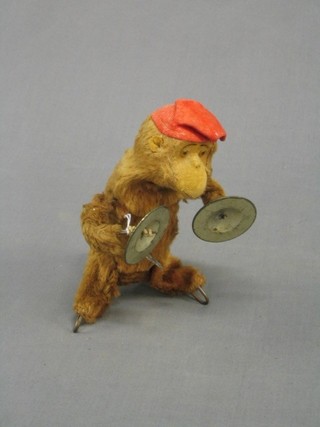 A Japanese clock work figure of a monkey with cymbals