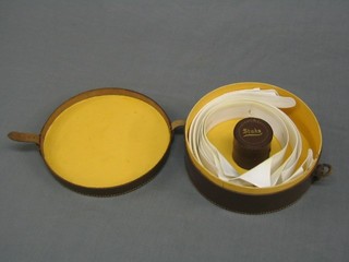 A circular leather collar box incorporating a stud box to the centre