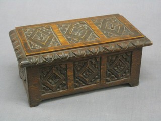 A reproduction 17th Century miniature carved oak coffer with hinged lid 9"