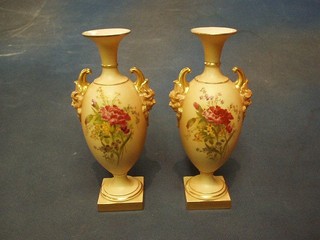 A handsome pair of Victorian Royal Worcester blush ivory twin handled vases with floral decoration, raised on square feet, the base with purple Worcester mark and 20 dots marked 1718, 9" (very slight rubbing on one vase to the rim gilt)