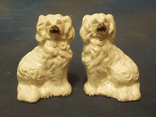 A pair of 19th Century white glazed Staffordshire figures of seated spaniels 6" (firing cracks)