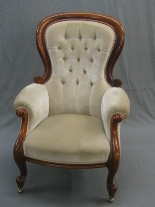A Victorian mahogany show frame spoon back armchair upholstered in white buttoned material, raised on cabriole supports