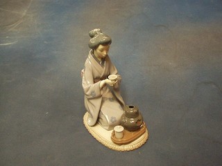 A Lladro figure of a seated Geisha girl taking tea, base marked Lladro and impressed B22E