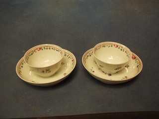 A pair of 18th Century famille vert porcelain tea bowls and saucers