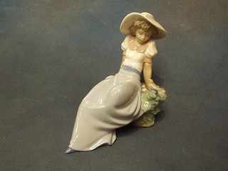 A Nao figure of a seated lady with bird 8"