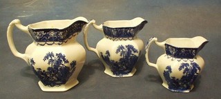 3 graduated blue and white pottery jugs